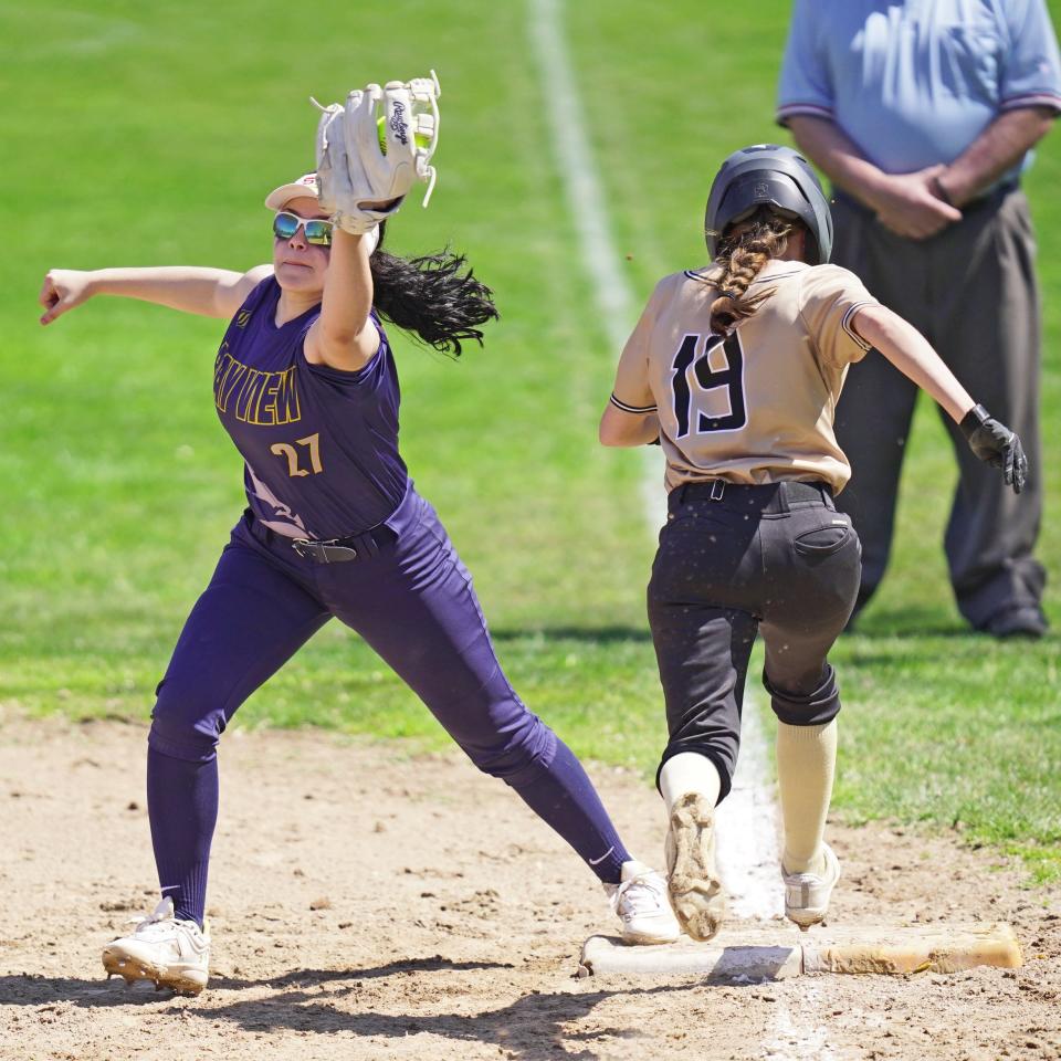 Bay View's Gianna Paolino, left, stretches to secure the ball and the out on a bunt during Monday's game against North Kingstown.