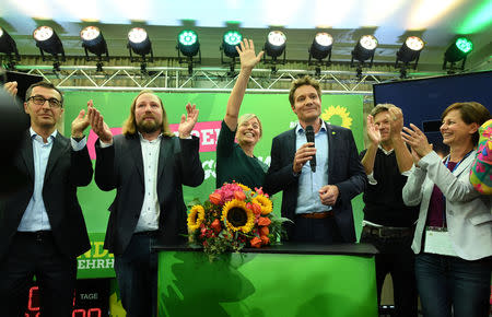 Katharina Schulze and Ludwig Hartmann top candidates of the Green Party celebreate with the other party members after the announcement of first exit polls in the Bavarian state elections in Munich, Germany, October 14, 2018. REUTERS/Andreas Gebert