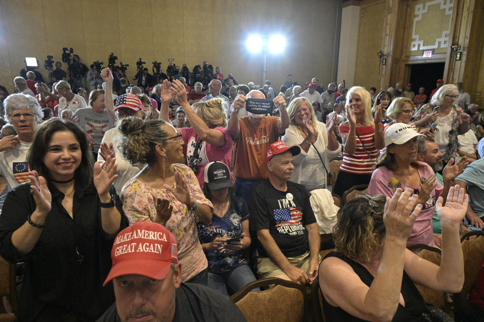 Attendees cheer during a rally featuring Rep. Matt Gaetz, R-Fla. and Rep. Marjorie Taylor Greene, R-Ga., Friday, May 7, 2021, in The Villages, Fla. (AP Photo/Phelan M. Ebenhack)