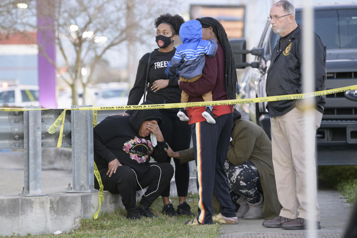 People react at the scene of a multiple fatality shooting at the Jefferson Gun Outlet in Metairie, La. Saturday, Feb. 20, 2021. A person went into a gun store and shooting range in a New Orleans suburb and fatally shot two people Saturday, causing customers and staff to open fire on the shooter, said a sheriff. The shooter also died.(AP Photo/Matthew Hinton)