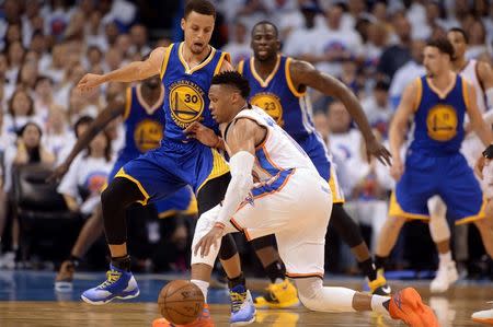 May 24, 2016; Oklahoma City, OK, USA; Oklahoma City Thunder guard Russell Westbrook (0) fights for position with Golden State Warriors guard Stephen Curry (30) during the third quarter in game four of the Western conference finals of the NBA Playoffs at Chesapeake Energy Arena. Mandatory Credit: Mark D. Smith-USA TODAY Sports