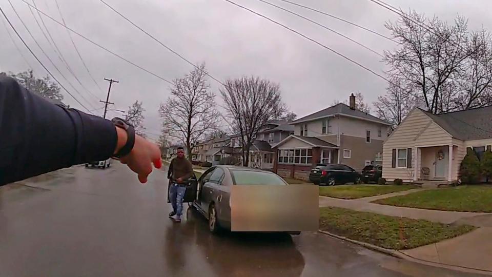 A police officer in Grand Rapids, Mich., points at 26-year-old Patrick Lyoya to get back into the car after a traffic stop on April 4, 2022. A confrontation ensued, and the officer fatally shot Lyoya.