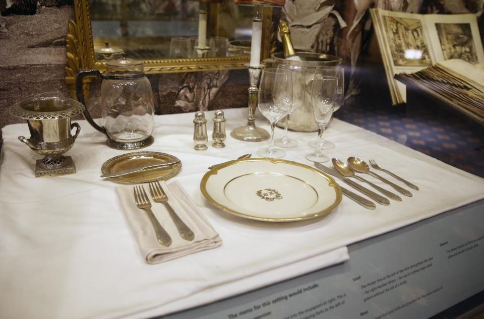 A place setting is displayed behind glass in the small museum off the lobby of the renowned Waldorf Astoria hotel, Tuesday, Feb. 28, 2017, in New York. The Waldorf Astoria's history dates to 1893, but its original home was torn down to make way for the Empire State Building. The "new" Waldorf Astoria's more than 40 stories opened on Park Avenue in 1931, built at a cost topping $40 million ($639 million in today's dollars) making it one of the world's largest and most expensive hotels at the time. (AP Photo/Kathy Willens)