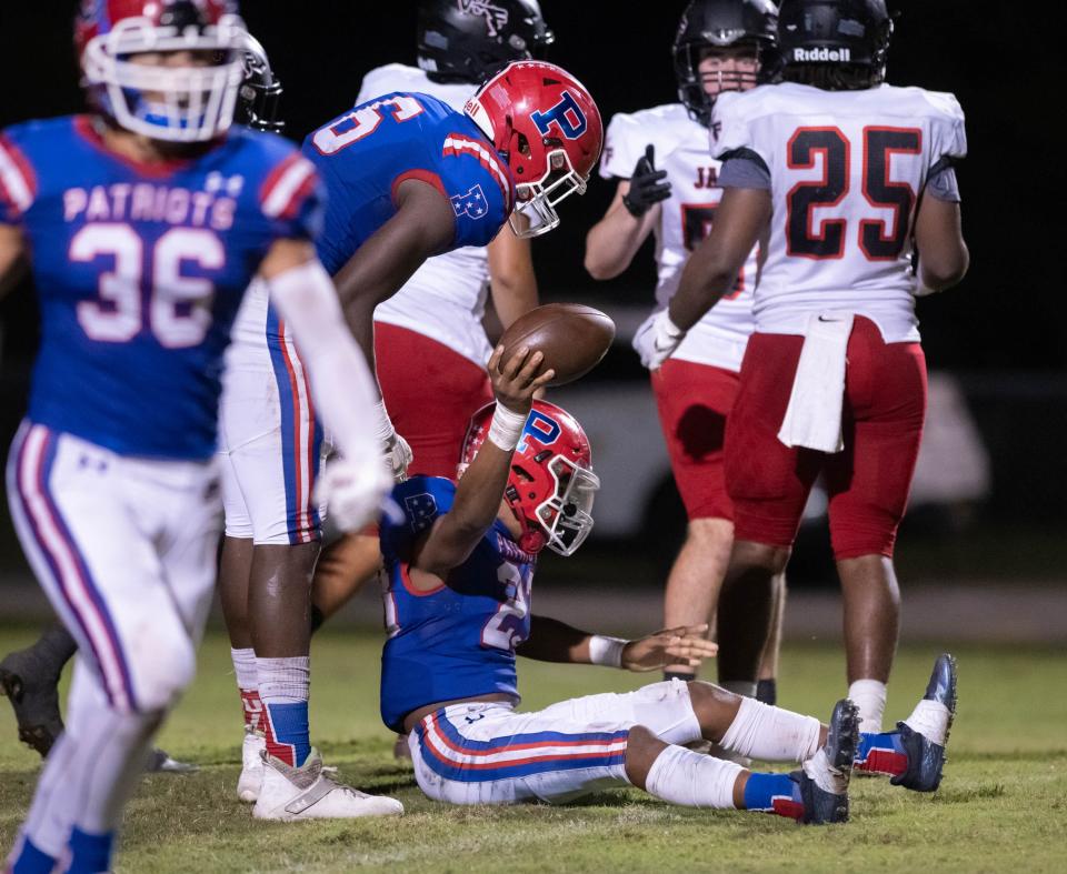 Cole Willis (33) has his punt blocked and recovered by Brayden Gates (23) of the Patriots during the West Florida vs Pace football game at Pace High School on Friday, Sept. 9, 2022.
