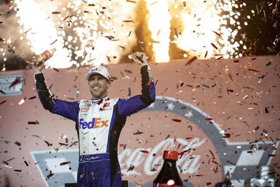 Denny Hamlin celebrates in Victory Lane after winning a NASCAR Cup Series auto race at Charlotte Motor Speedway, Sunday, May 29, 2022, in Concord, N.C. (AP Photo/Matt Kelley)