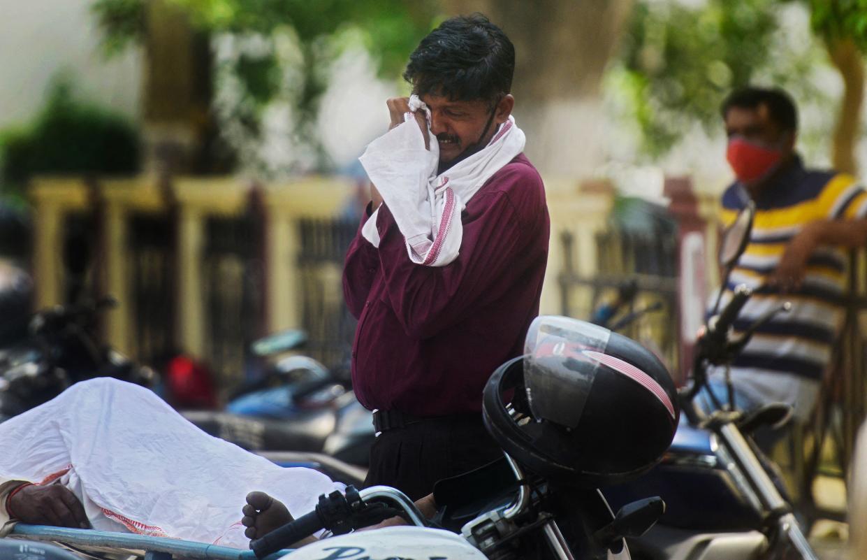 A relative a Covid-19 coronavirus victim grieves outside a hospital in Allahabad on April 29, 2021.