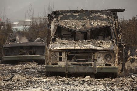 Burnt vehicles are pictured after much of the area was consumed by the Carlton Complex Fire near Methow, Washington July 19, 2014. T REUTERS/David Ryder