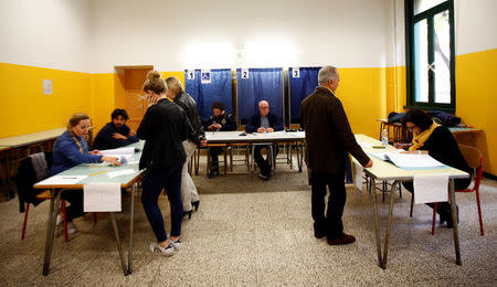 Residents arrive to cast their electronic votes for the Lombardy's autonomy referendum at a polling station in Milan, Italy, October 22, 2017. REUTERS/Alessandro Garofalo