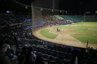 The stadium is partially empty during the opening winter season game between Los Leones de Caracas and Los Tigres de Aragua in Caracas, Venezuela, Tuesday, Nov. 5, 2019. A deepening crisis has left her nation in shambles, and a recent curve ball from the Trump administration has prevented big league players in the MLB from taking the field, stripping away star-power that fans have come to expect over decades. (AP Photo/Ariana Cubillos)