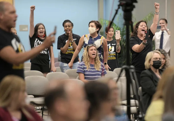 Audience members join Ben Frazier, founder of the Northside Coalition of Jacksonville, in chanting, “Allow teachers to teach the truth,” on Thursday at the Florida State College at Jacksonville’s Advanced Technology Center, during public comments on the state’s plans to ban the teaching of critical race theory in state public schools.