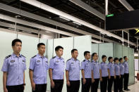 Immigration officers stand in formation in the Mainland Port Area at West Kowloon Station, which houses the terminal for the Guangzhou-Shenzhen-Hong Kong Express Rail Link (XRL), developed by MTR Corp., in Hong Kong, China, September 22, 2018. Giulia Marchi/Pool via REUTERS