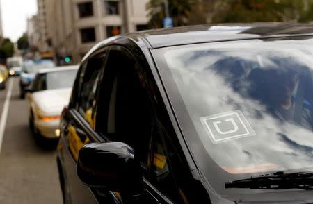 The Uber logo is seen on a vehicle near Union Square in San Francisco, California, U.S. May 7, 2015. REUTERS/Robert Galbraith/Files
