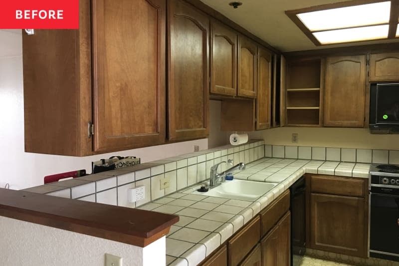 Dark wood cabinets in kitchen before renovation.