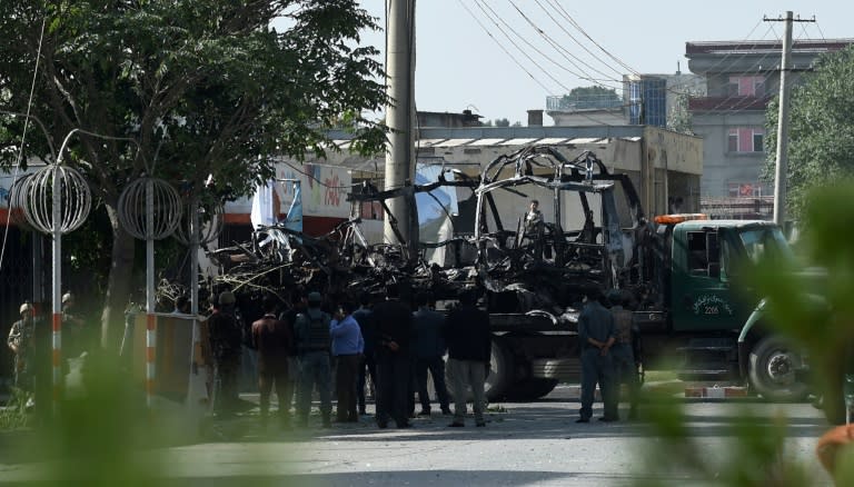 Afghan security forces remove a damaged bus after a car bomb attack in western Kabul on July 24, 2017