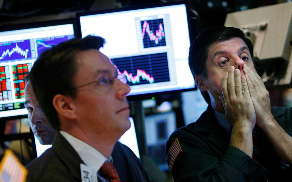 A trader rubs his face while working on the floor of the New York Stock Exchange October 7, 2008 in New York City. Is another recession on the cards? (Photo by Mario Tama/Getty Images)