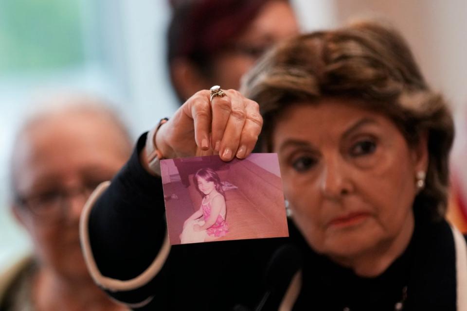 Attorney Gloria Allred holds up a picture of Jessica Taylor during a press conference on Thursday (AP)