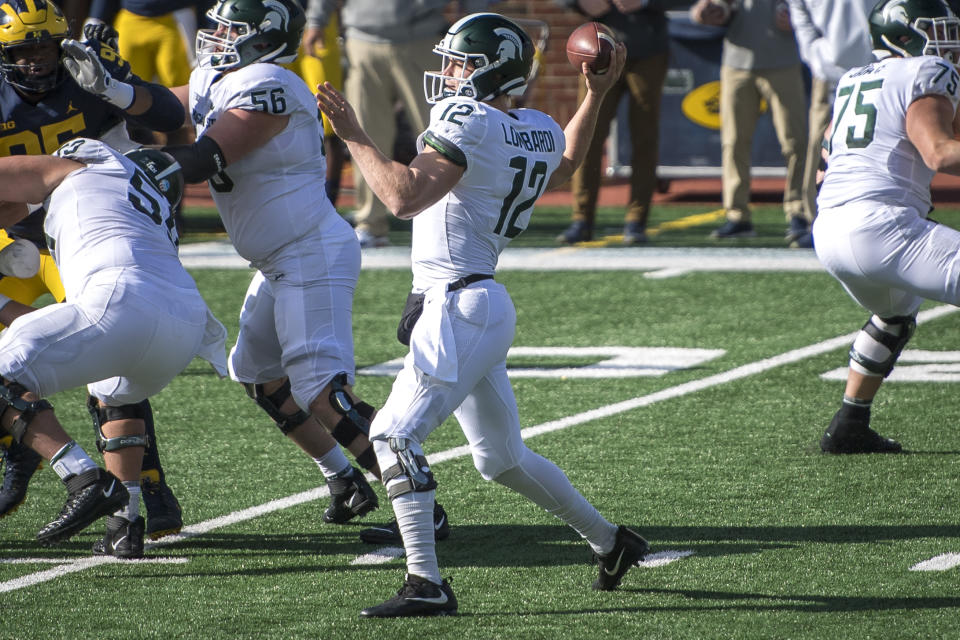 ANN ARBOR, MI - OCTOBER 31: Rocky Lombardi #12 of the Michigan State Spartans throws a pass during the first quarter against the Michigan Wolverines at Michigan Stadium on October 31, 2020 in Ann Arbor, Michigan. (Photo by Nic Antaya/Getty Images)