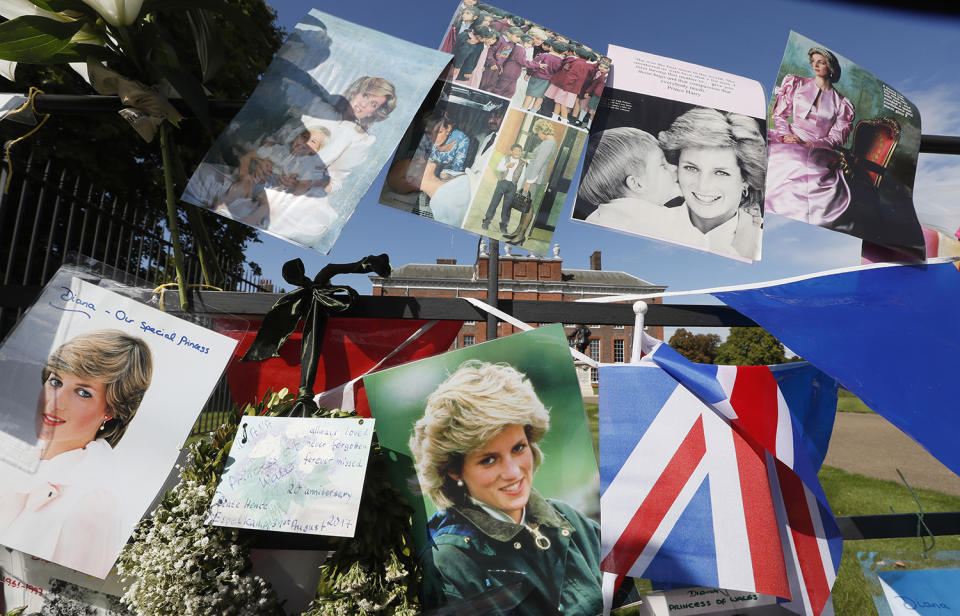 <p>Pictures and flags hang on the gates of Kensington Palace in London to pay tribute to the late Diana, Princess of Wales, Aug. 31, 2017. (Photo: Kirsty Wigglesworth/AP) </p>