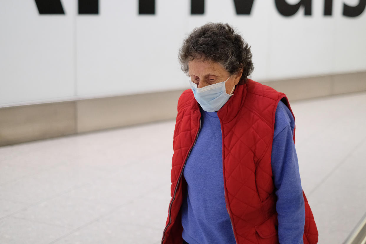 Passengers arriving at Heathrow Airport wear face masks as four patients are tested for coronavirus in Scotland (SWNS)