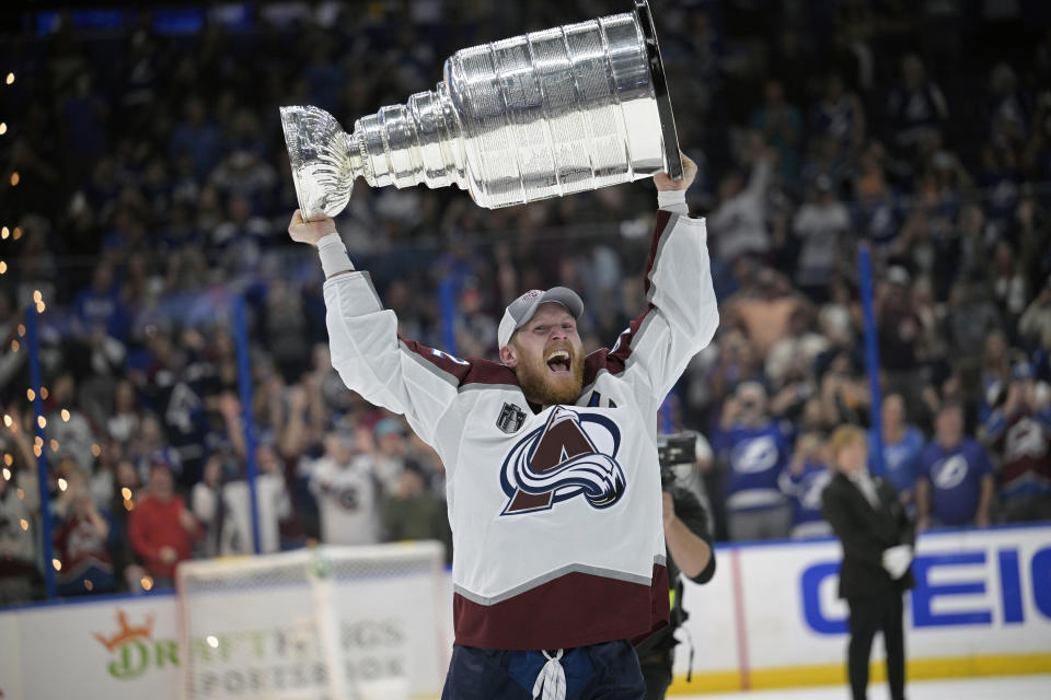 FILE - Colorado Avalanche left wing Gabriel Landeskog lifts the Stanley Cup after the team defeated the Tampa Bay Lightning in Game 6 of the NHL hockey Stanley Cup Finals on Sunday, June 26, 2022, in Tampa, Fla. Landeskog is set to undergo cartilage transplant surgery and expected to miss the entire 2023-24 NHL season. The team on Tuesday, May 9, announced that Landeskog will have the operation Wednesday in Chicago. (AP Photo/Phelan M. Ebenhack, File)