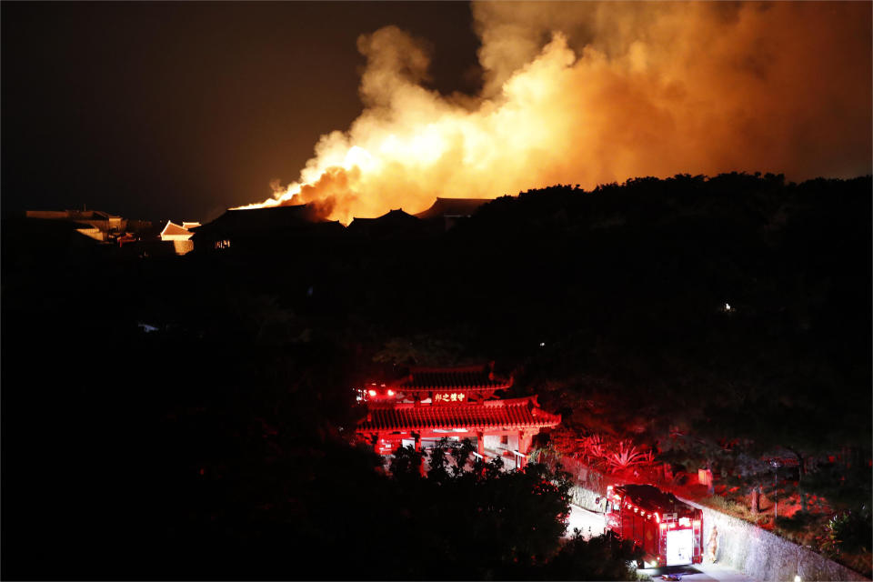 Smoke and flames rise from burning Shuri Castle in Naha, Okinawa, southern Japan, Thursday, Oct. 31, 2019. A fire broke out at the historic Shuri Castle on Japan’s southern island of Okinawa, nearly destroying it. The gate seen in the foreground is Shureimon. (Jun Hirata/Kyodo News via AP)