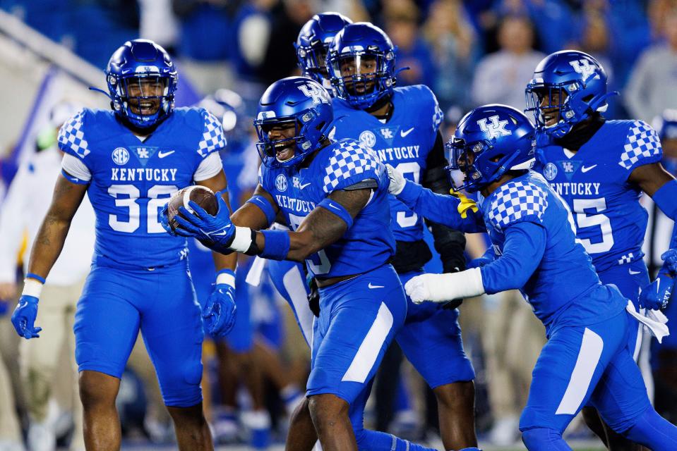 Kentucky linebacker DeAndre Square (5) celebrates with teammates after intercepting a Mississippi State pass during the second half of an NCAA college football game in Lexington, Ky., Saturday, Oct. 15, 2022. (AP Photo/Michael Clubb)