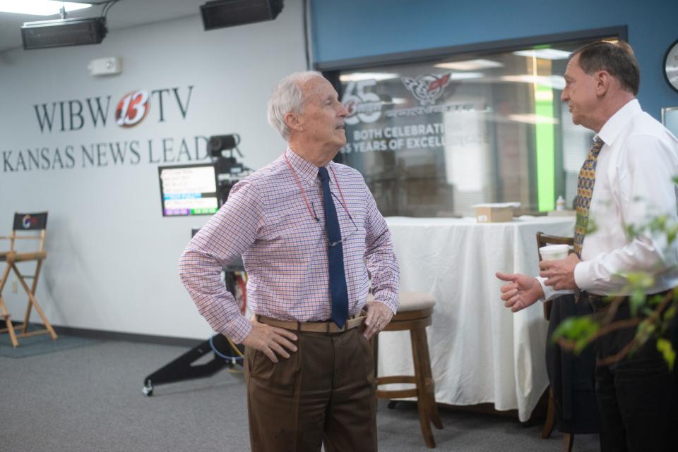 WIBW-13 news director Jon Janes, left, chats with anchor Ralph Hipp following the 4 p.m. newscast Wednesday.