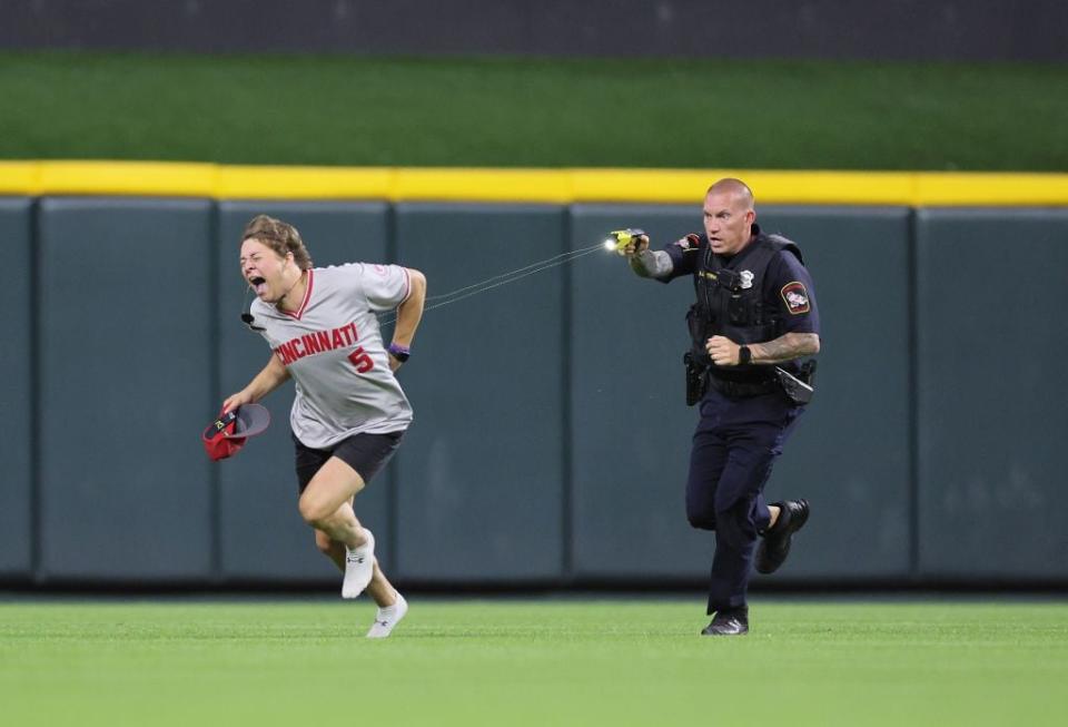 CINCINNATI, OHIO - JUNE 11:  An unidentified fan is tased by a police officer as he runs on the field before the ninth inning of the Cincinnati Reds against Cleveland Guardians at Great American Ball Park on June 11, 2024 in Cincinnati, Ohio. (Photo by Andy Lyons/Getty Images)