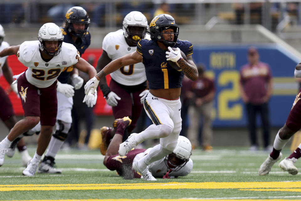 California running back Jaydn Ott (1) runs against Arizona State linebacker Caleb McCullough (22) during the first half of an NCAA college football game in Berkeley, Calif., Saturday, Sept. 30, 2023. (AP Photo/Jed Jacobsohn)