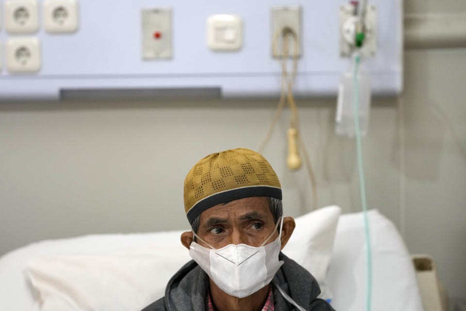 Misnar, a street vendor who suffers from pneumonia, sits on his bed at Persahabatan Hospital in Jakarta, Indonesia, on Sept. 22, 2023. Pollution is causing respiratory illnesses and deaths to rise in Indonesia's island of Java, including the capital, Jakarta. Data gathered by IQAir, a Swiss air technology company, regularly ranks Jakarta as one of the most polluted cities in the world. Blue skies are a rare sight and the air often smells like fuel or heavy smoke. (AP Photo/Achmad Ibrahim)