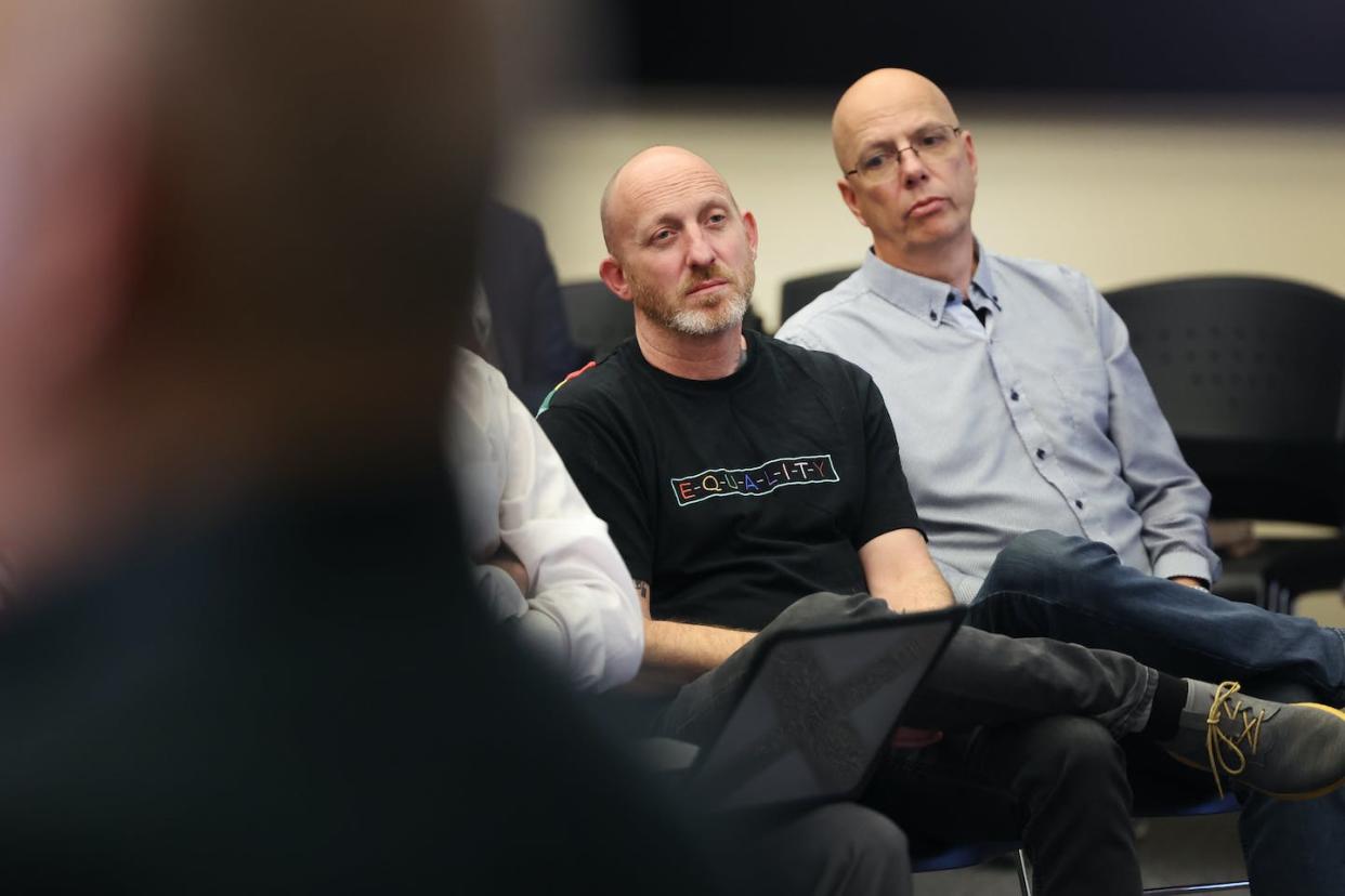 Club Q co-owners Nic Grzecka, left, and Matthew Haynes listen during a police news conference on Nov. 21, 2022, in Colorado Springs, Colo. <a href="https://www.gettyimages.com/detail/news-photo/club-q-co-owners-nic-grzecka-and-matthew-haynes-listen-to-news-photo/1443386018?phrase=club%20q&adppopup=true" rel="nofollow noopener" target="_blank" data-ylk="slk:Scott Olson/Getty Images;elm:context_link;itc:0;sec:content-canvas" class="link ">Scott Olson/Getty Images</a>