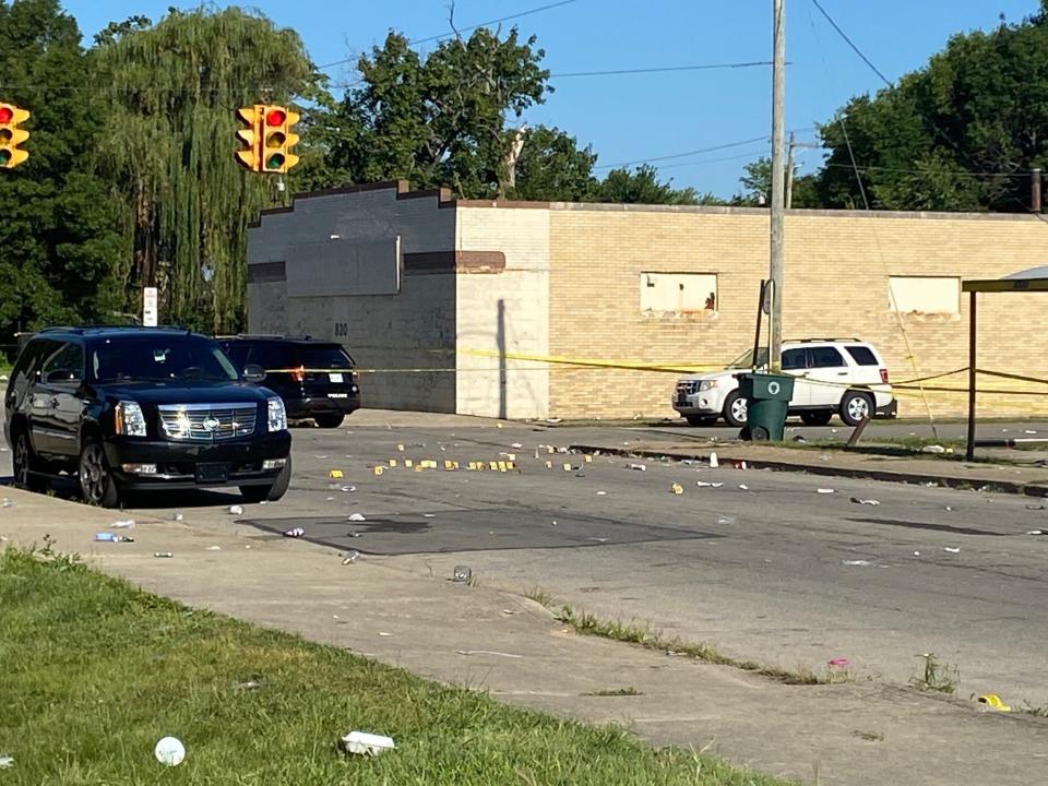 Police marked the position of spent cartridges in the street following the July 30 shooting that killed one and wounded 17 at Hackley and Willard streets in central Muncie.