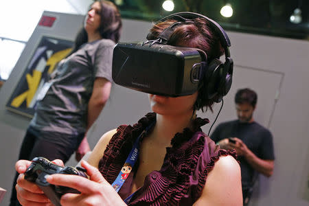 A woman uses the Oculus Rift virtual reality headset at the 2014 Electronic Entertainment Expo, known as E3, in Los Angeles, June 10, 2014. REUTERS/Jonathan Alcorn