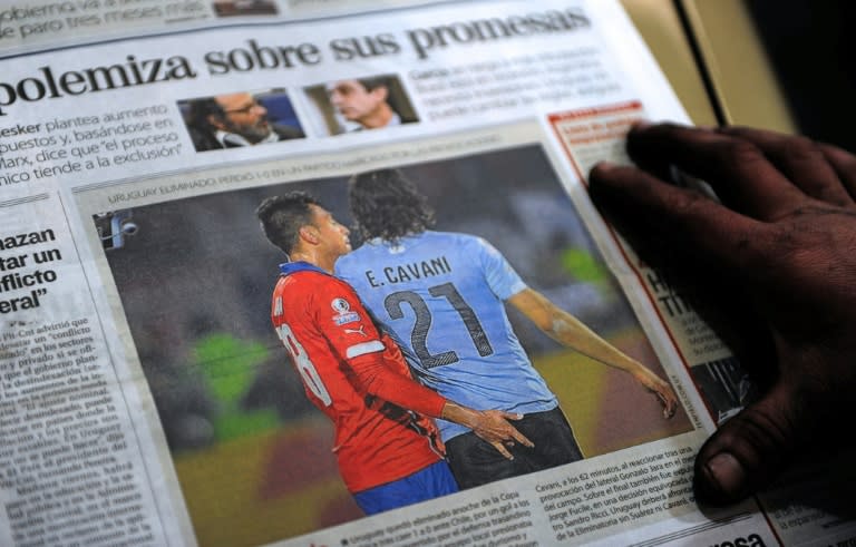 The front page of an Uruguayan newspaper shows photo of Chile's defender Gonzalo Jara provoking Uruguay's Edinson Cavani during their Copa America quarter-final match in Santiago on June 24, 2015