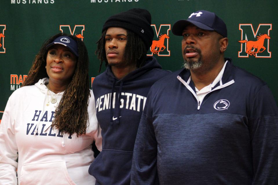 Mandarin cornerback Jon Mitchell, a Penn State signee, is flanked by parents Nicole and Kevin Mitchell during early signing day ceremonies.