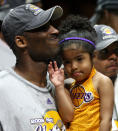 In this June 14, 2009, photo, Los Angles Lakers guard Kobe Bryant celebrates with his daughter Gianna, following the Lakers 99-86 defeat of the Orlando Magic in Game 5 of the NBA Finals at Amway Arena in Orlando. (Stephen M. Dowell/Orlando Sentinel via AP)