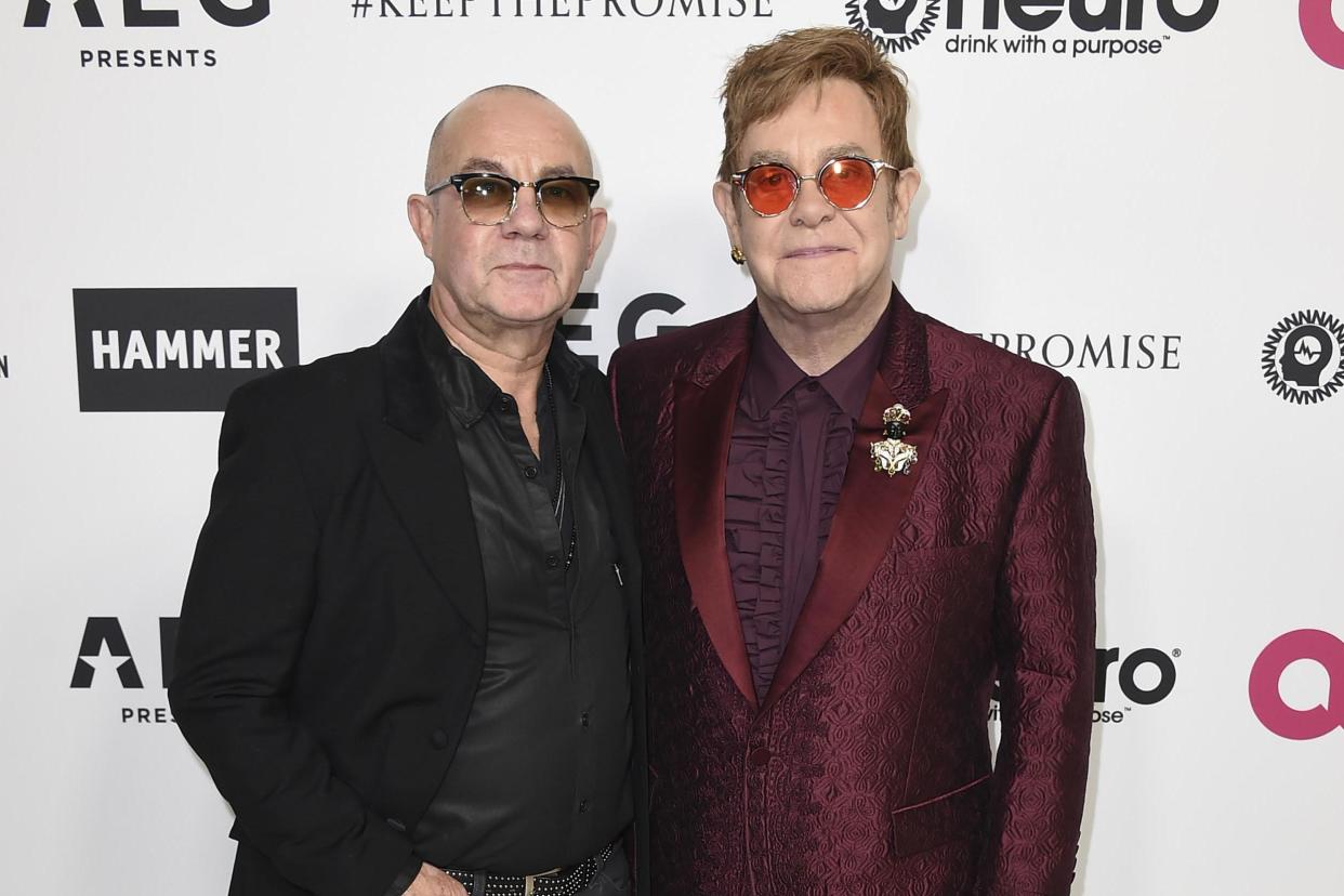 Elton John and Bernie Taupin arrive at Rocket Man star's 70th birthday: Jordan Strauss/Invision/AP