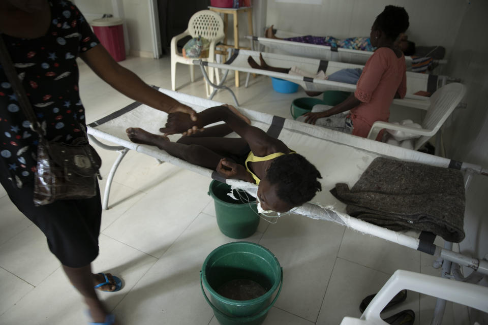 A child suffering from cholera symptoms vomits at a clinic run by Doctors Without Borders, in the Delmas neighborhood of Port-au-Prince, Haiti, Thursday, Nov. 10, 2022. Across Haiti, many patients are dying because say they’re unable to reach a hospital in time, health officials say. (AP Photo/Odelyn Joseph)