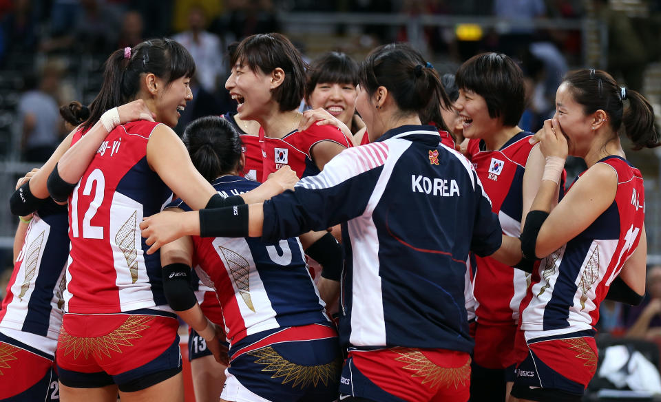 LONDON, ENGLAND - AUGUST 07: Team Korea celebrates the win over Italy during Women's Volleyball quarterfinals on Day 11 of the London 2012 Olympic Games at Earls Court on August 7, 2012 in London, England. (Photo by Elsa/Getty Images)