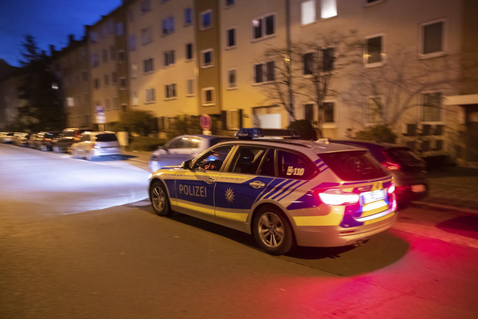 A police car patrols through the St. Johannis district in Nuremberg, southern Germany, Friday, Dec. 14, 2018 where three women had been stabbed and wounded the evening before. (Daniel Karmann/dpa via AP)