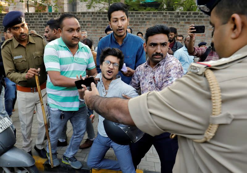 Police detain a demonstrator during a protest in Ahmedabad