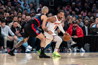 New York Knicks guard Jalen Brunson, right, drives to the basket against Detroit Pistons guard Evan Fournier during the first half of an NBA basketball game in New York, Monday, March 25, 2024. (AP Photo/Peter K. Afriyie)