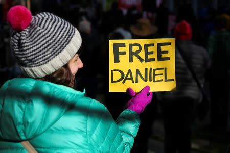 A woman holds a sign outside of the U.S. District Court during a rally in support of Daniel Ramirez Medina, who was detained by U.S. immigration authorities, in Seattle, Washington, U.S. February 17, 2017. REUTERS/David Ryder