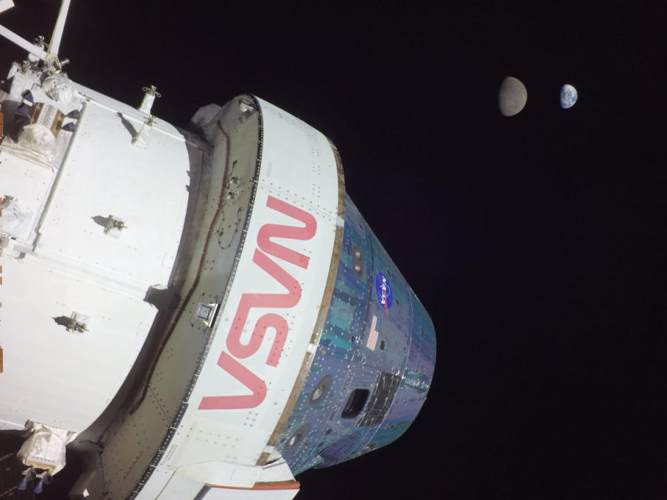 A view of NASA's Artemis 1 Orion spacecraft with the moon and Earth in the background