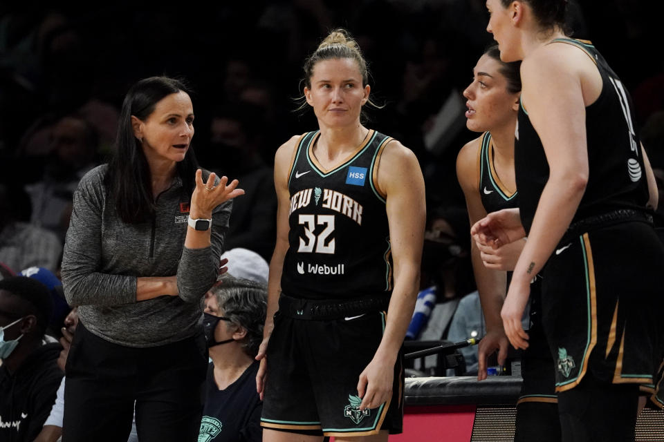 New York Liberty head coach Sandy Brondello, left, speaks with her players in the second half during a WNBA basketball game against the Connecticut Sun, Tuesday, May 17, 2022, in New York. (AP Photo/John Minchillo)