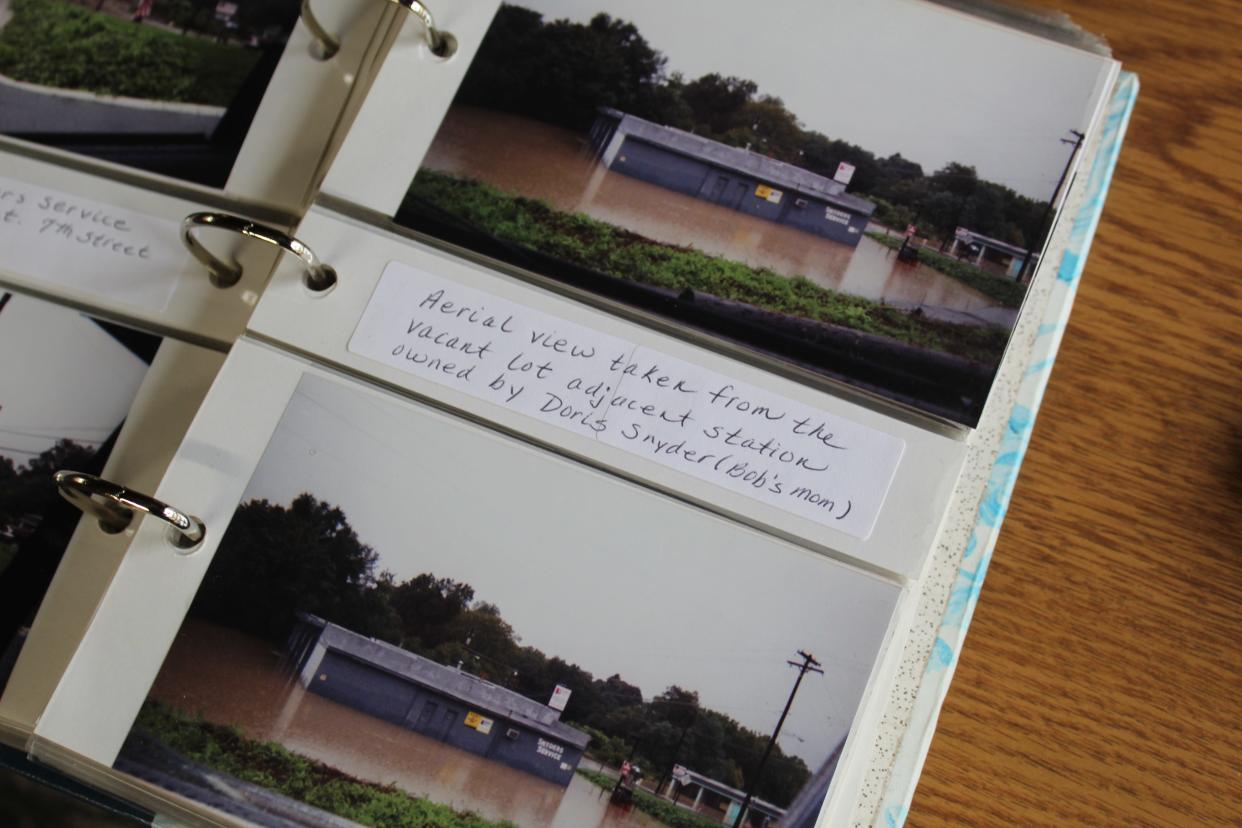 Kim Snyder keeps photos of the flooding in a scrapbook.