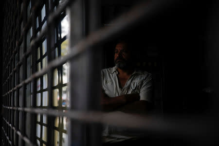 A man stands inside a restaurant during a blackout in Caracas, Venezuela March 7, 2019. REUTERS/Carlos Garcia Rawlins