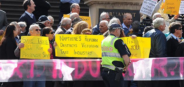 Taxi drivers and their families protest on the steps of state parliament in Melbourne, Tuesday, Oct. 15, 2013. Photo: AAP