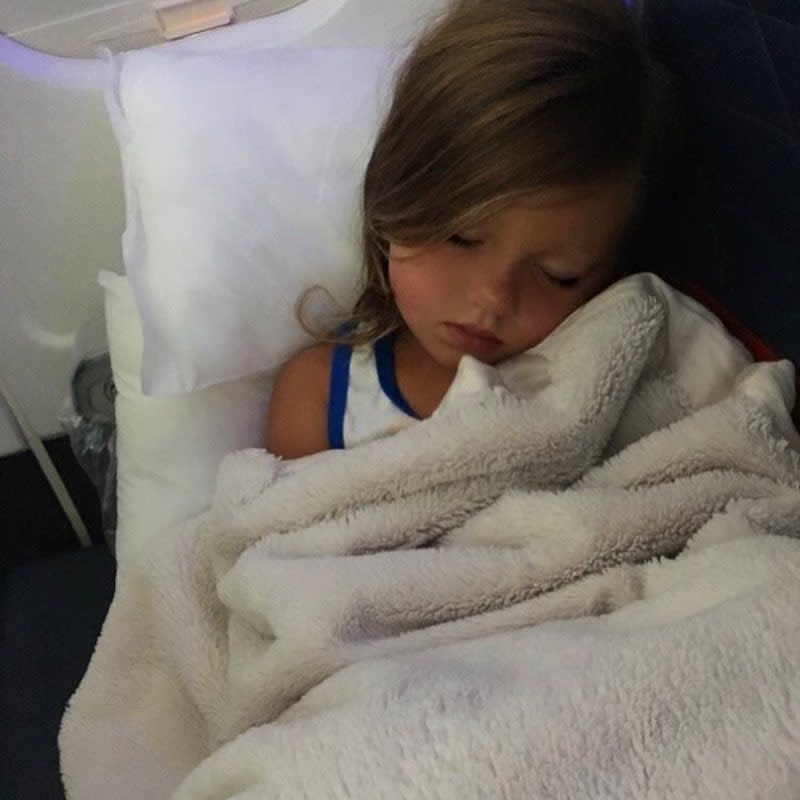 <p>On their way home, little Kaia passed out on the plane. “My view right now,” wrote Kim. (Photo: <a rel="nofollow noopener" href="https://www.instagram.com/p/BVF4O4jBloR/" target="_blank" data-ylk="slk:Kim Zolciak-Biermann via Instagram;elm:context_link;itc:0;sec:content-canvas" class="link ">Kim Zolciak-Biermann via Instagram</a>) </p>