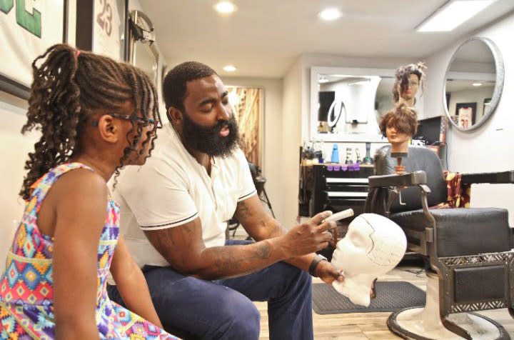 Second-grader and new barber Neijae Graham-Henries with her mentor, P. Michael Boone. (Photo: Courtesy of P. Michael Boone)